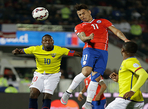 Chile's Eduardo Vargas and Ecuador's Walter Ayovi go for a header during a Copa America Group 1 soccer match at the National Stadium in Santiago, Chile. AP photo