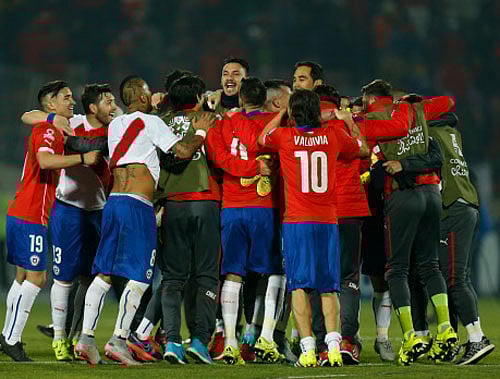 Chile's players celebrate at the end of the Copa America semifinal soccer match against Peru at the National Stadium in, Santiago, Chile. AP