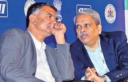 Karnataka Minister for Agriculture Krishna Byre Gowda lends a ear to CII President S Gopalakrishnan at CII Partnership Summit in Bangalore on Wednesday. Dh Photo/ Savitha B R