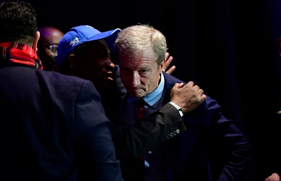 Democratic Presidential candidate entrepreneur Tom Steyer talks with supporters as he leaves following his announcement that he is suspending his campaign at his election night party on the day of the South Carolina Presidential Primary in Columbia, South