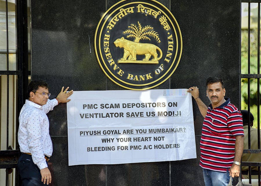 Punjab and Maharashtra Cooperative (PMC) Bank's depositors hold placards and raise slogans during a protest outside Reserve Bank of India at BKC, in Mumbai, Sunday, Dec. 15, 2019. (PTI Photo)