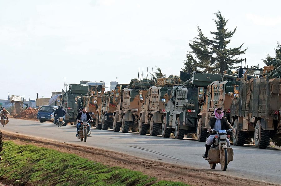 A Turkish military convoy drives near the town of Batabu on the highway linking Idlib to the Syrian Bab al-Hawa border crossing with Turkey. (AFP Photo)