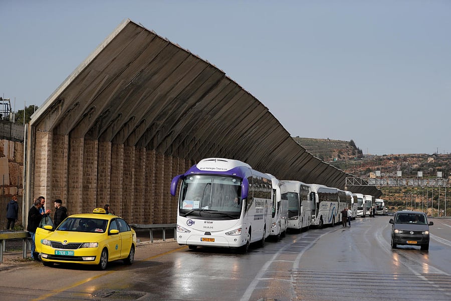 Tourist busses wait near an Israeli checkpoint as preventive measures are taken against the coronavirus, in Bethlehem in the Israeli-occupied West Bank. Reuters