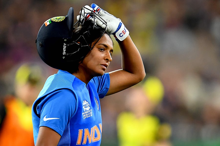 India's captain Harmanpreet Kaur walks back to the pavilion after her dismissal during the Twenty20 women's World Cup cricket final match between Australia and India in Melbourne. (AFP Photo)