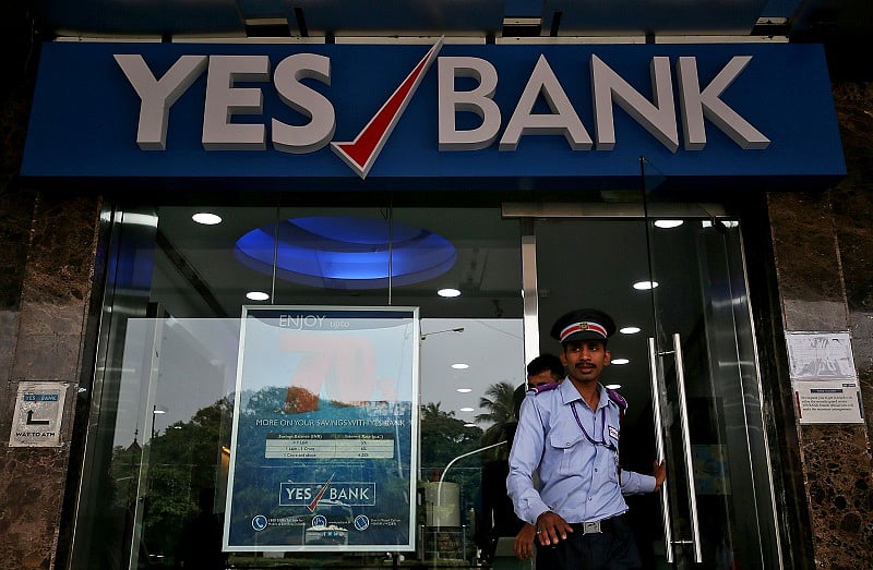 A watchman steps out of a Yes Bank branch in Mumbai, India. (Reuters Photo)
