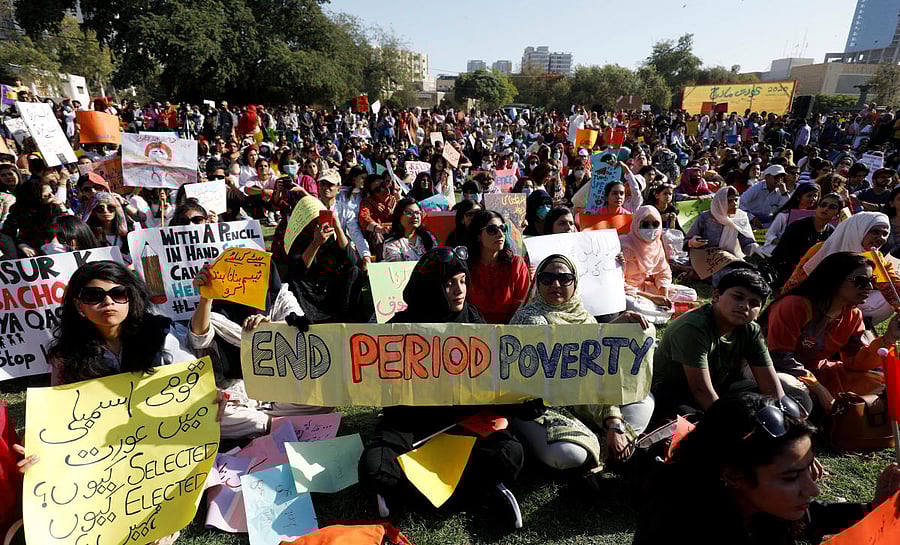 Participants carry signs as they attend the Aurat March (Women's March) in Karachi, Pakistan March 8, 2020. REUTERS/Akhtar Soomro