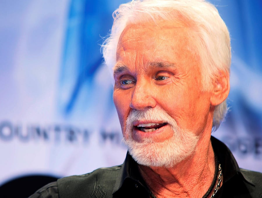 Kenny Rogers poses after accepting the Willie Nelson Lifetime Achievement award. Reuters