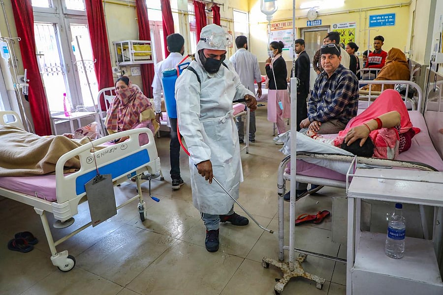 A worker sprays disinfectants inside a hospital as a measure to prevent the spread of coronavirus (COVID-19) pandemic, in Jammu (PTI Photo)