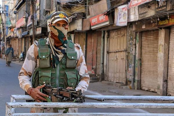 A securityman keeps vigil on a closed street during the lockdown in the wake of coronavirus outbreak, in Jammu, Monday, March 23, 2020. (PTI Photo)