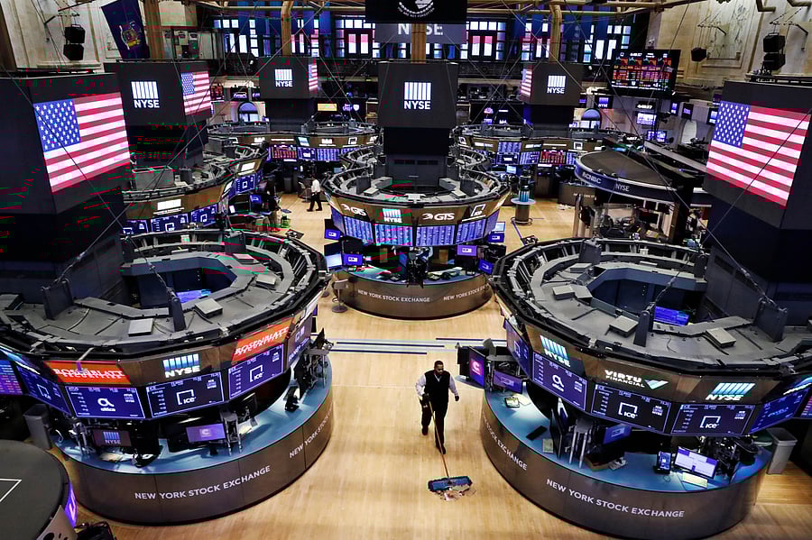 A worker cleans the floor of the New York Stock Exchange (NYSE) as the building prepares to close indefinitely. (Credit: Reuters)