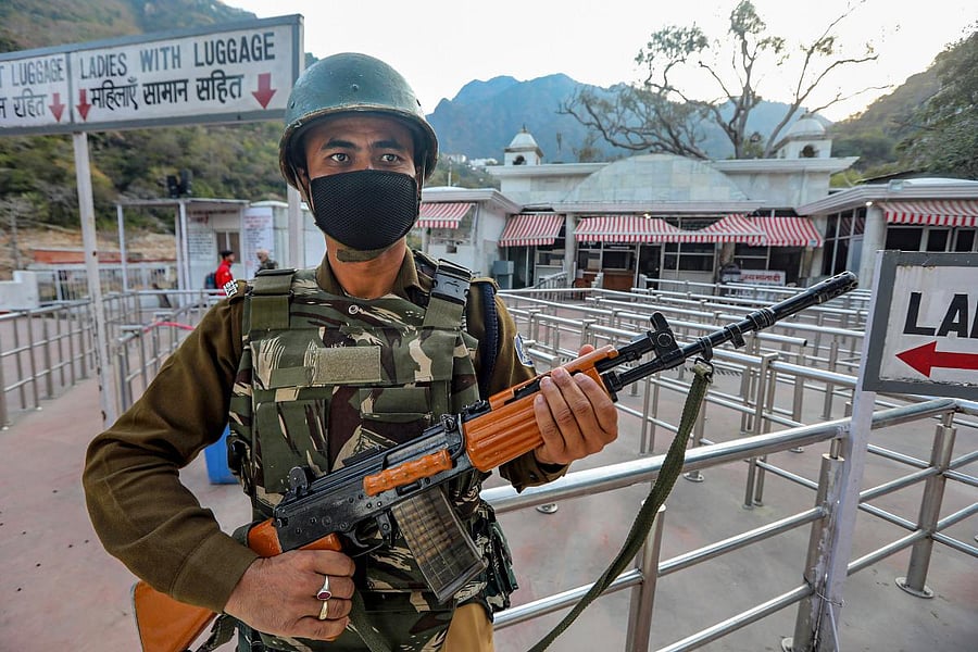 CRPF personnel stand guard in the empty premises of Ban Ganga Darshani Deodi after the government suspended pilgrimage. PTI