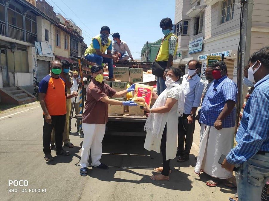 MLA S A Ramdas hands-over groceries to a resident in Mysuru, on behalf of Reliance retail on Tuesday.