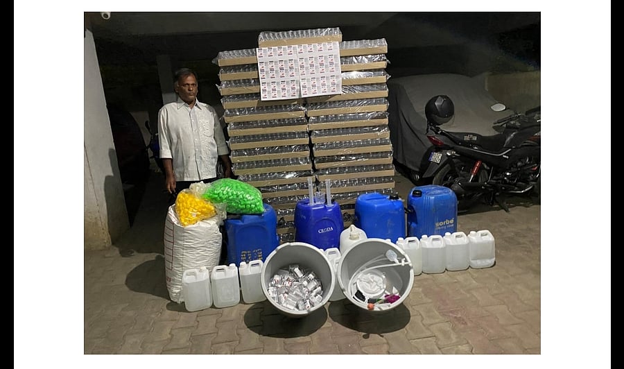 Shiva Kumar with fake sanitisers. (DH Photo)