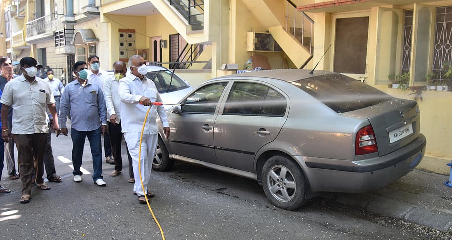 Ramalingareddy MLA with BBMP workers spray Sodium Hypochlorite, to prevent Caronavirus, Covid-19 at Chamundi Park, 8th block, Koramangala in Bengaluru on Friday. (Photo by S K Dinesh)