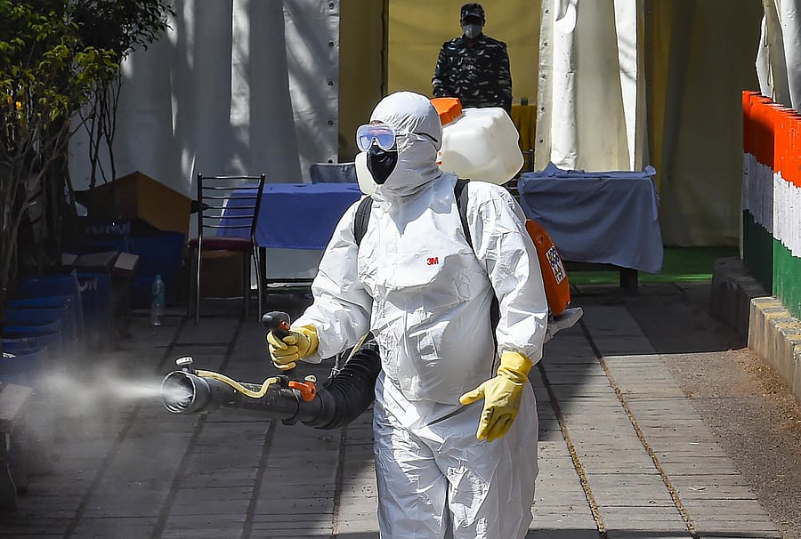 A health worker sanitises an area near Nizamuddin mosque, after people who attended the religious congregation at Tabligh-e-Jamaat's Markaz, tested postive for COVID-19, in New Delhi, Wednesday, April 1, 2020. Credit: PTI Photo