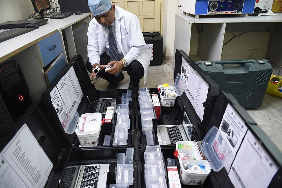 Scientist and founder of Online Telemedicine Research Institute, Ragesh Shah checks the contents of the kits prepared for the coronavirus scanning and surveillance system, in Ahmedabad. AFP