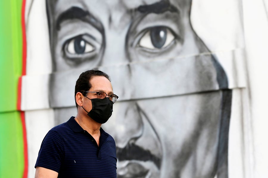 A Saudi man walks past a poster depicting Saudi King Salman bin Abdulaziz. (Reuters file photo)