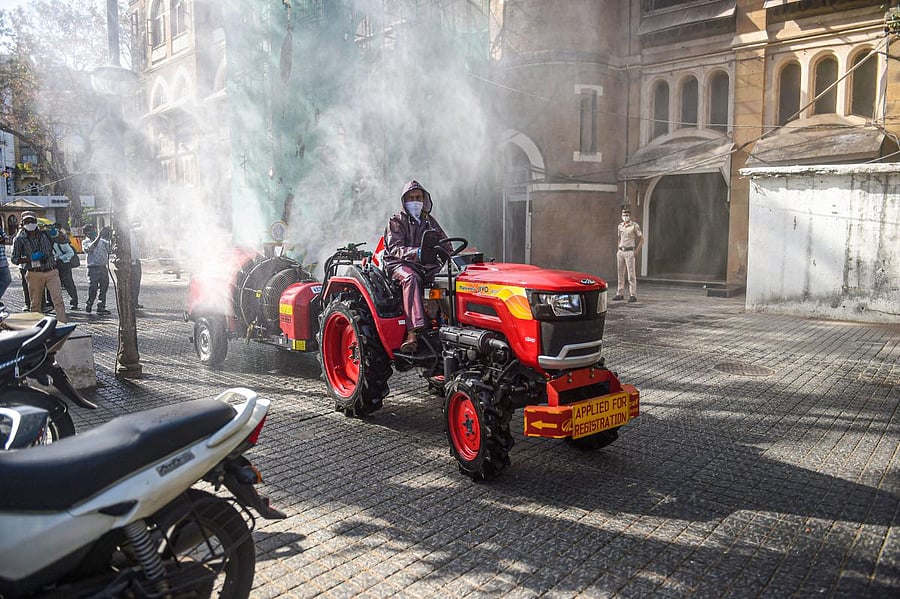 Municipal workers spray disinfectant in the premises of Mumbai Commissioner's office during the nationwide lockdown. PTI