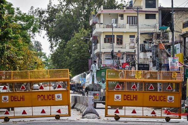 A worker sprays disinfectant on a street at Dilshad Garden, marked as a COVID-19 hotspot, during the nationwide lockdown to curb the spread of coronavirus, in New Delhi. (PTI Photo/Arun Sharma)