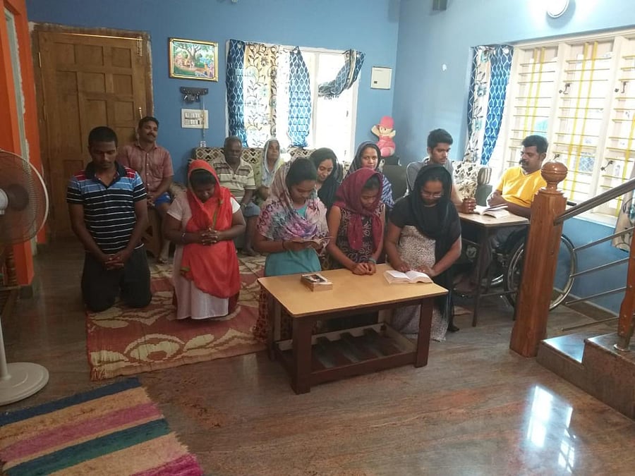 People pray at their residence in Kodagu on the occasion of Good Friday.