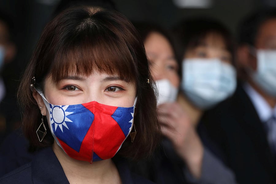 A staff wears a face mask with a Taiwanese flag design, as protection due to the coronavirus disease (COVID-19) outbreak, at a factory for non woven filter fabric used to make surgical face masks, in Taoyuan. Credit: Reuters File Photo