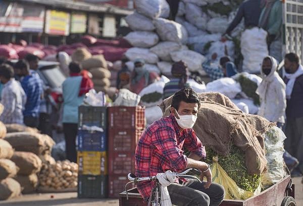A vendor selling vegetables waits for customers at Sahibabad market, during the nationwide lockdown to curb the spread of coronavirus, in Ghaziabad. (PTI Photo/Atul Yadav)