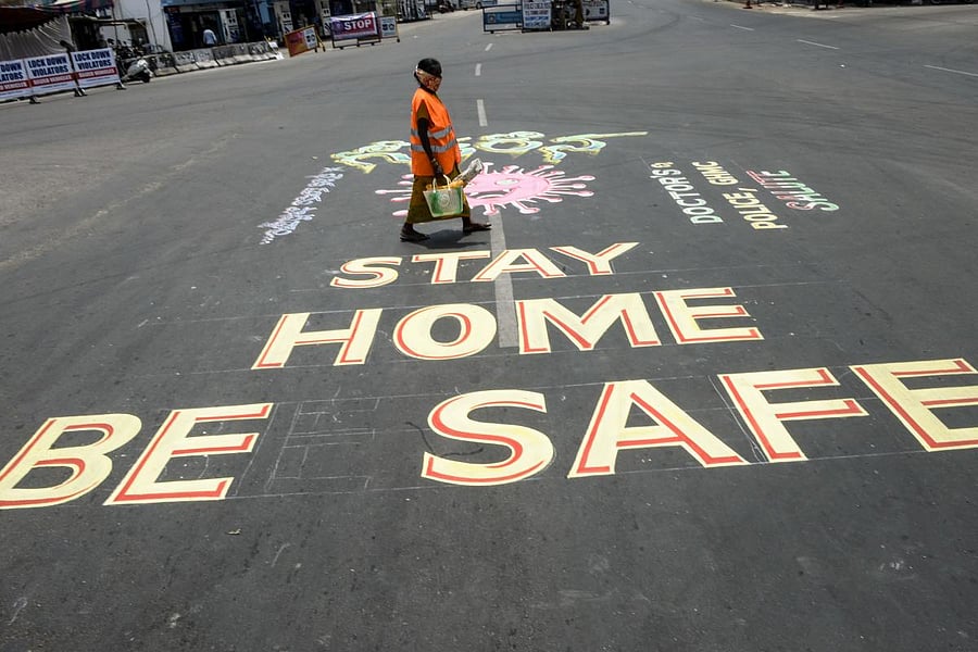 A municipal corporate worker walks past a graffiti drawn at a traffic junction in Andhra (AFP Photo)