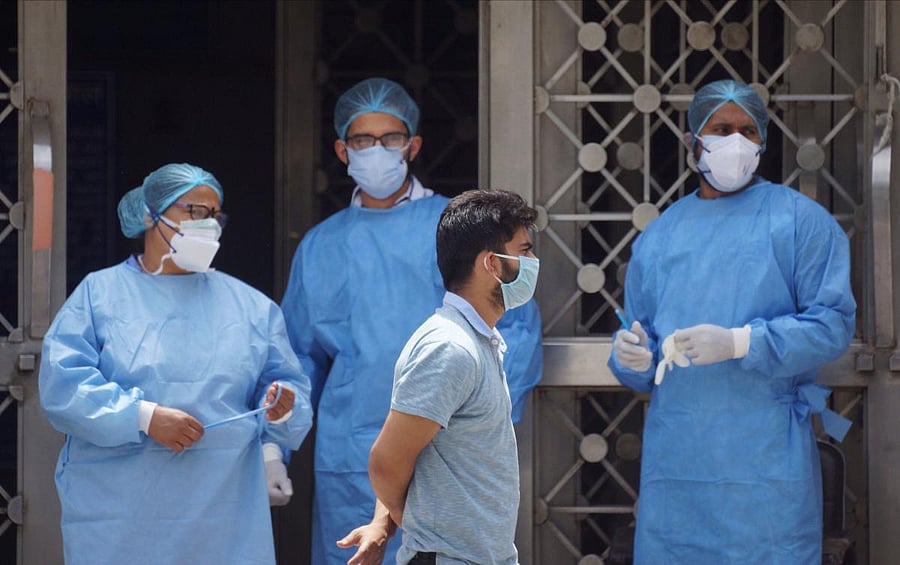 Medics wearing protective suits are seen in the premises of LNJP Hospital during the nationwide lockdown (PTI Photo)