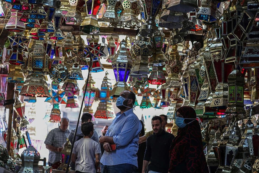 Egyptians look at traditional lanterns known in Arabic as "Fanous" sold during the Muslim holy month of Ramadan in Cairo's Sayeda Zainab neighbourhood, on April 19, 2020. Credit: AFP Photo