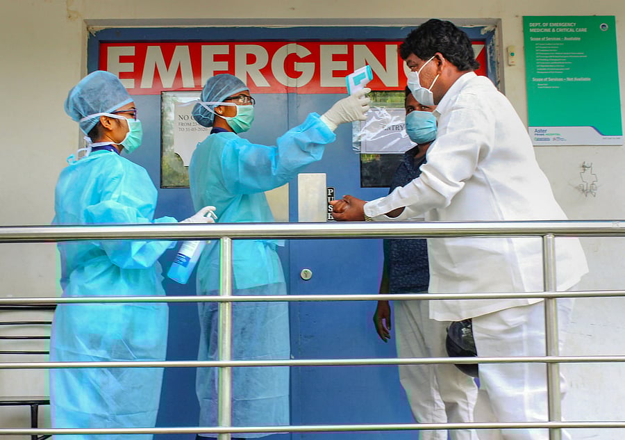 Thermal screening of visitors being conducted outside an emergency ward at a hospital during a nationwide lockdown in the wake of coronavirus pandemic in Hyderabad. (Credit: PTI Photo)