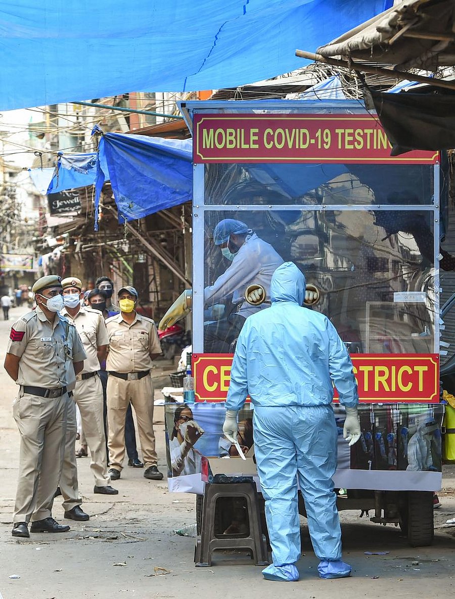 Policemen stand in a queue in front of the mobile COVID-19 testing van (PTI Photo)