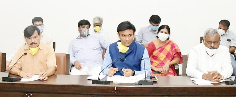Medical Education Minister Dr K Sudhakar addresses media persons in Mysuru on Tuesday. MLA S A Ramdas and District In-charge Minister S T Somashekar are seen.