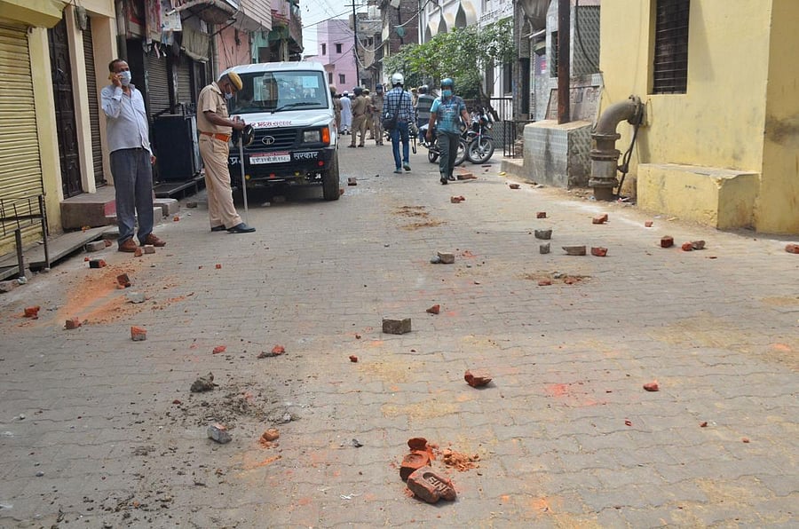 Brick-bats lie on on a road after a violent mob pelted stones at health workers, doctors and police officials in Moradabad (PTI Photo)
