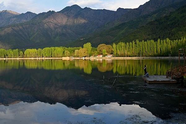 People fish at Dal lake during a government-imposed nationwide lockdown as a preventive measure against the COVID-19 coronavirus, in Srinagar on April 21, 2020. (Credit: AFP Photo by Tauseef Mustafa)