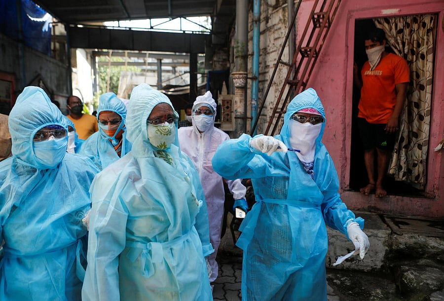 Healthcare workers enter a resedential area to check residents during a nationwide lockdown to slow the spreading of the coronavirus disease (COVID-19), in Mumbai, India. Credit: Reuters Photo