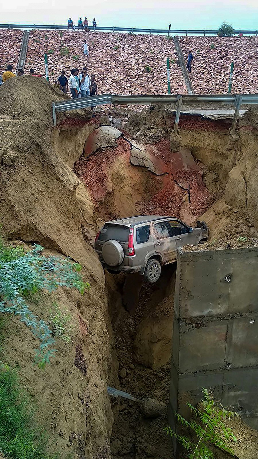 A vehicle trapped in a ditch at a damaged service road of the Agra-Lucknow Expressway near Agra. PTI