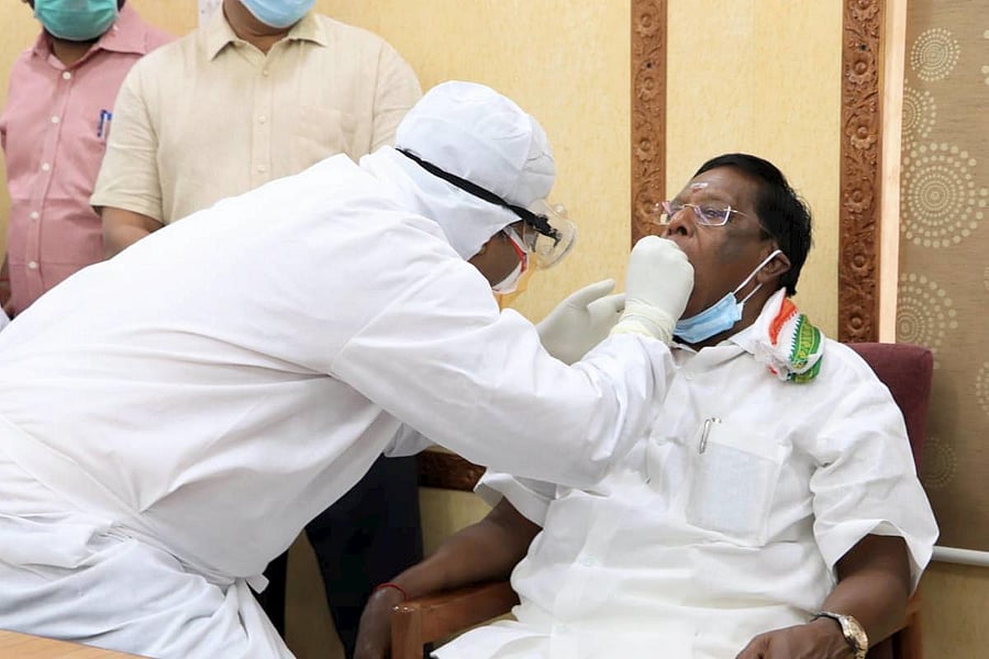 Puducherry Chief Minister V Narayanasamy gives swab sample to a medic for COVID-19 test (PTI Photo)