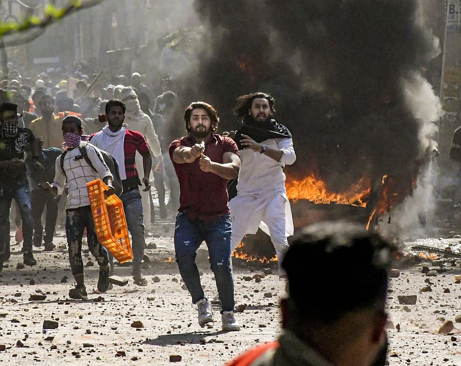 Mohammed Shahrukh brandishes a pistol during clashes between a group of anti-CAA protestors and supporters of the new citizenship act. (PTI Photo)