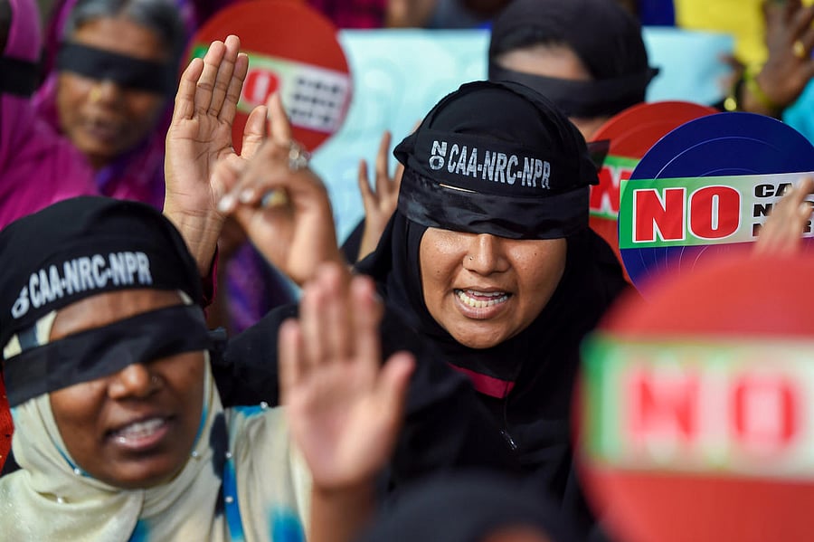 Demonstrators wear blindfolds as they raise slogans during a protest against the Citizenship Amendment Act. (PTI File Photo)