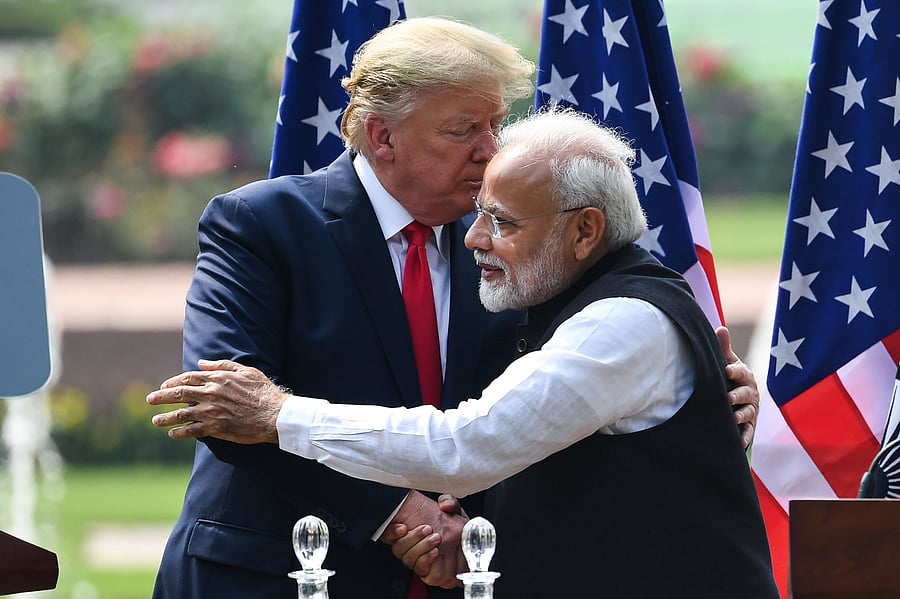 Prime Minister Narendra Modi (R) and US President Donald Trump hug each other after their joint press statement. (Credit: AFP)