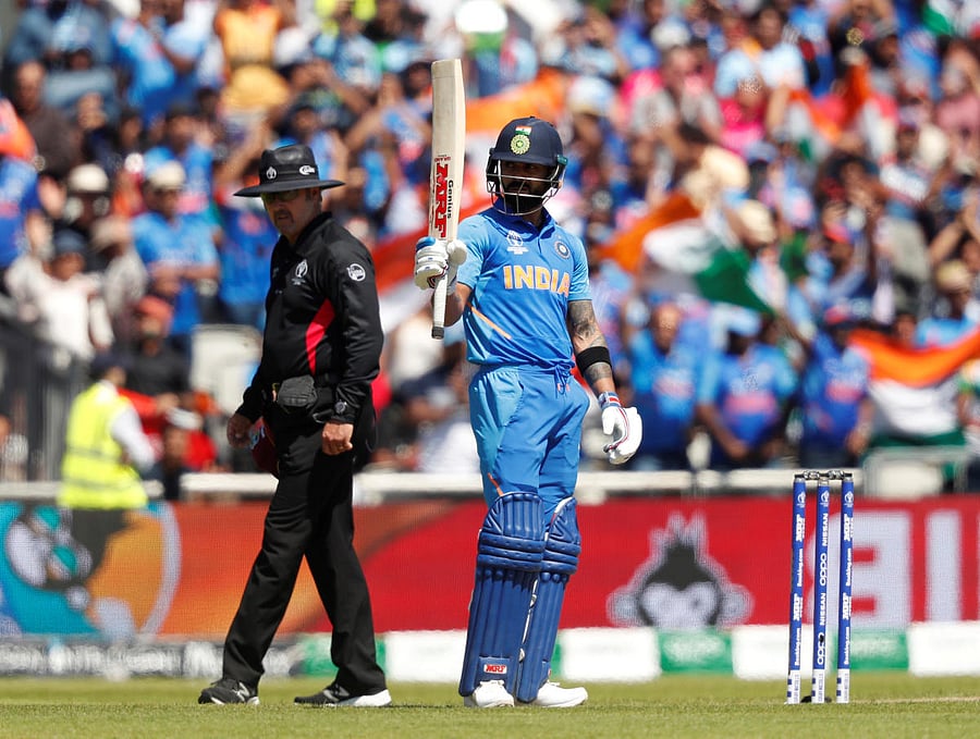 India's Virat Kohli celebrates his half century against West Indies. Photo credit: Reuters