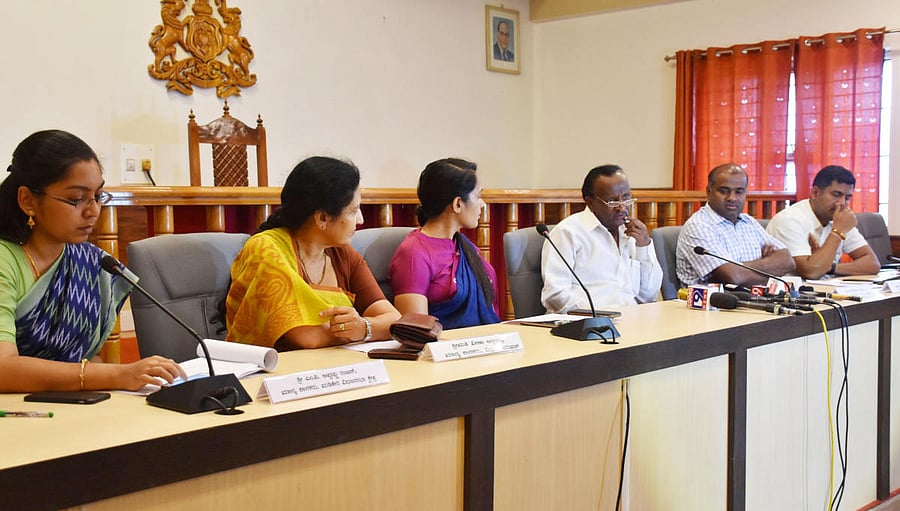 Housing Minister M T B Nagaraj (third from right) speaks to reporters in Madikeri on Saturday.