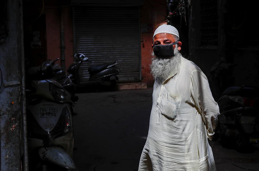 A Muslim man wears a protective mask as he walks through a lane during an extended nationwide lockdown to slow the spread of the coronavirus disease (COVID-19), in the old quarters of Delhi, India, April 15, 2020. Credit: Reuters Photo