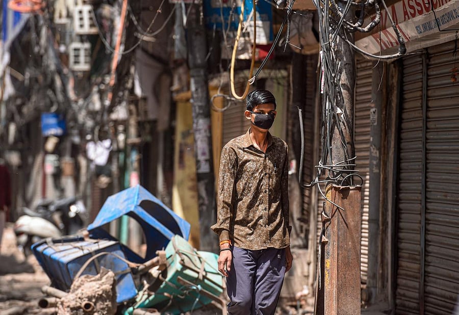 A young boy is seen wearing a mask at Chawari Bazar during the nationwide lockdown imposed in the wake of coronavirus pandemic, in New Delhi, Saturday, April 11, 2020. Credit: PTI Photo