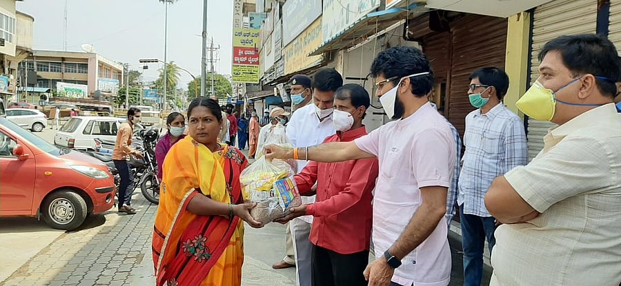 District In-charge Minister C T Ravi distributes grocery kits to members of Gondali community at M G Road in Chikkamagaluru.