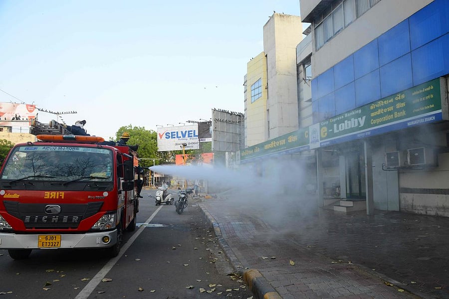 Firefighters from Ahmedabad Fire and Emergency Services spray disinfectant amid coronavirus crisis (AFP Photo)