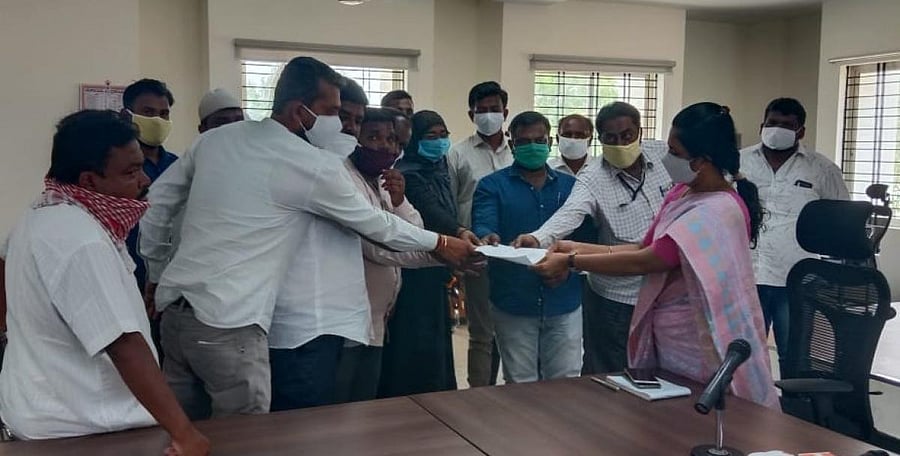 CMC members submit a memorandum to deputy commissioner C Satyabhama seeking disciplinary action against health inspector Maria in Kolar on Tuesday.
