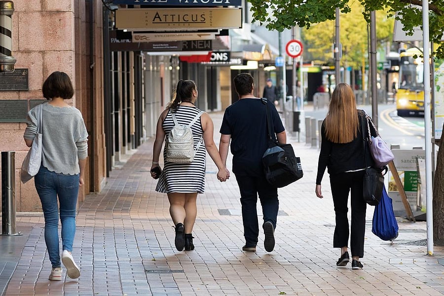People walk down a street on the first day of the easing of restrictions in Wellington. AFP