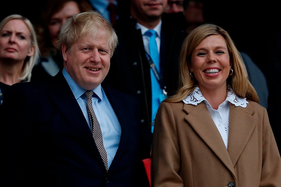 Britain's Prime Minister Boris Johnson (L) with his partner Carrie Symonds. (AFP Photo)