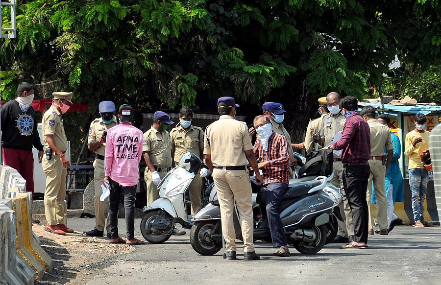 Police personnel question commuters for stepping out of their houses, during the nationwide lockdown to curb the spread of coronavirus, in Hyderabad, Thursday, April 23, 2020. (PTI Photo)